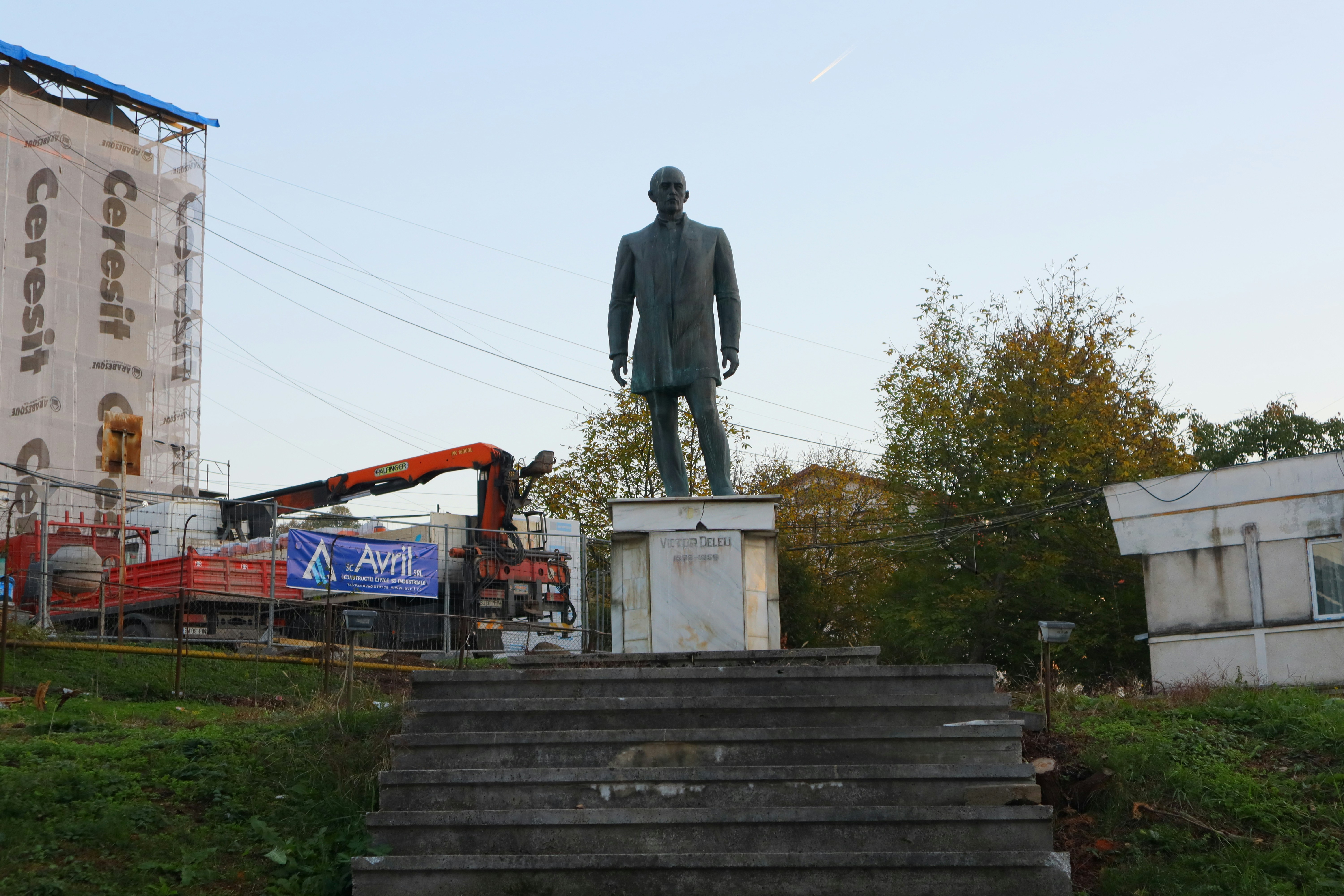 A statue of a man standing on top of a set of steps