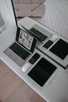 A laptop computer sitting on top of a white table