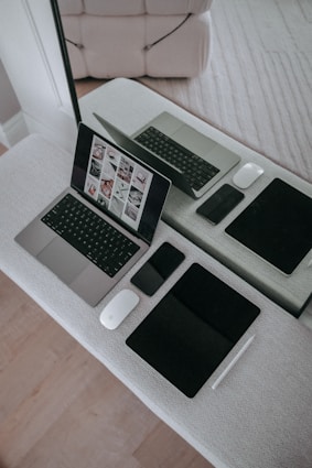 A laptop computer sitting on top of a white table