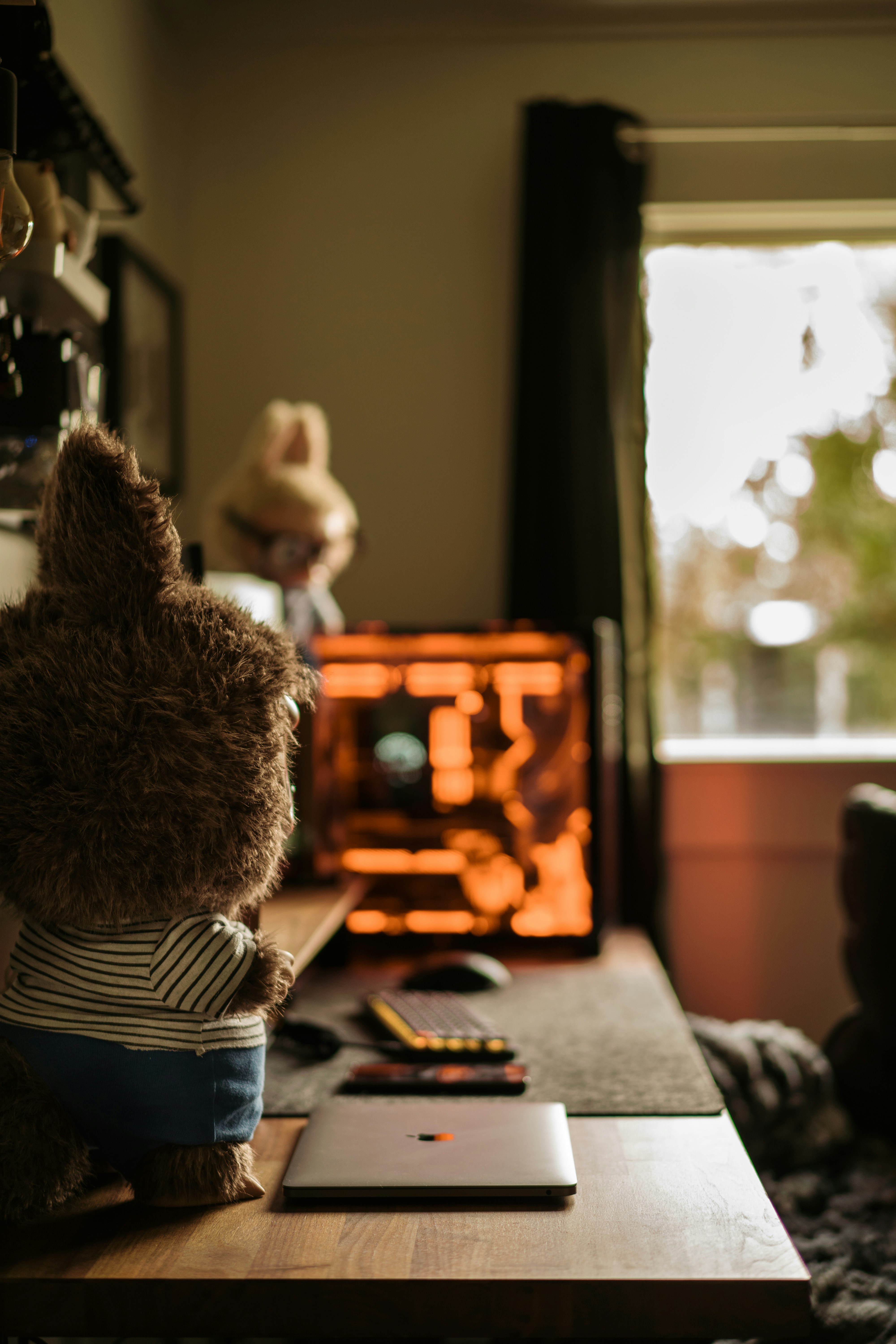A teddy bear sitting on a table in front of a window