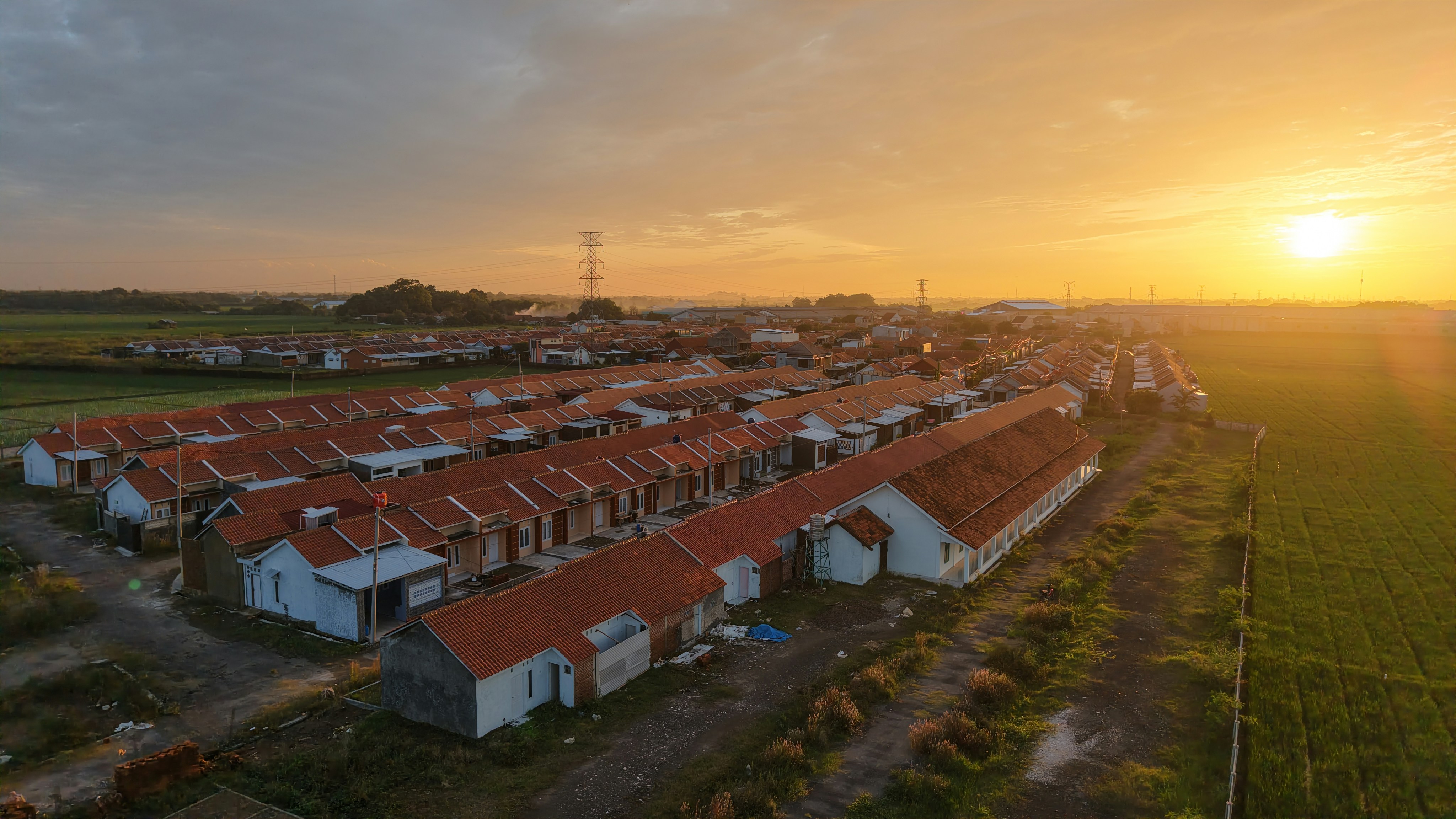 An aerial view of a village at sunset