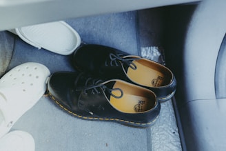 A pair of shoes sitting on the floor of a car