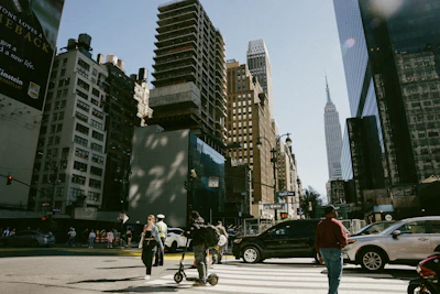 A group of people crossing a street in a city