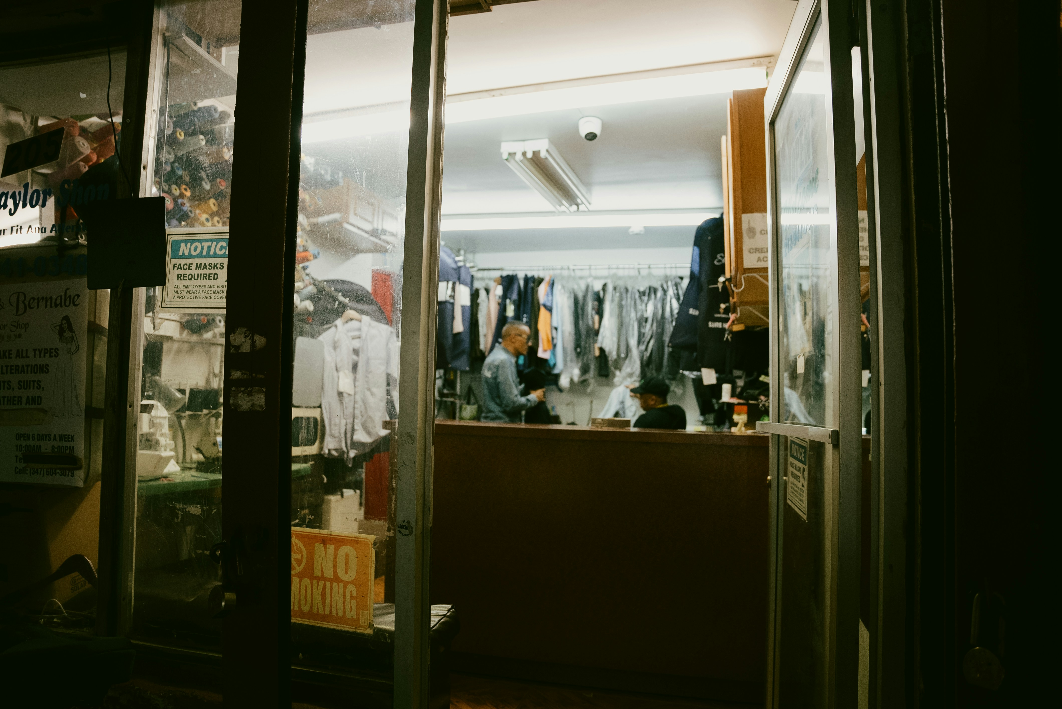 A store front at night with the lights on