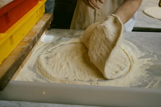 A person in a kitchen preparing food on a counter