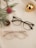 A pair of glasses sitting on top of a white towel