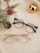 A pair of glasses sitting on top of a white towel