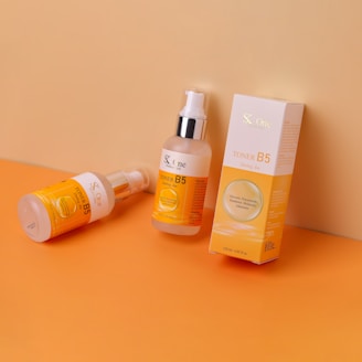 A bottle of sunscreen and a tube of sunscreen on a table