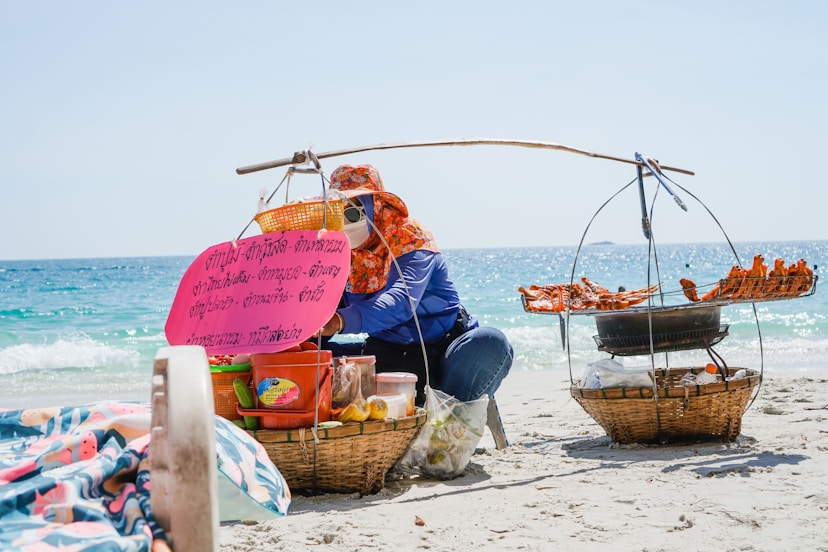 A woman sitting in a boat on the beach