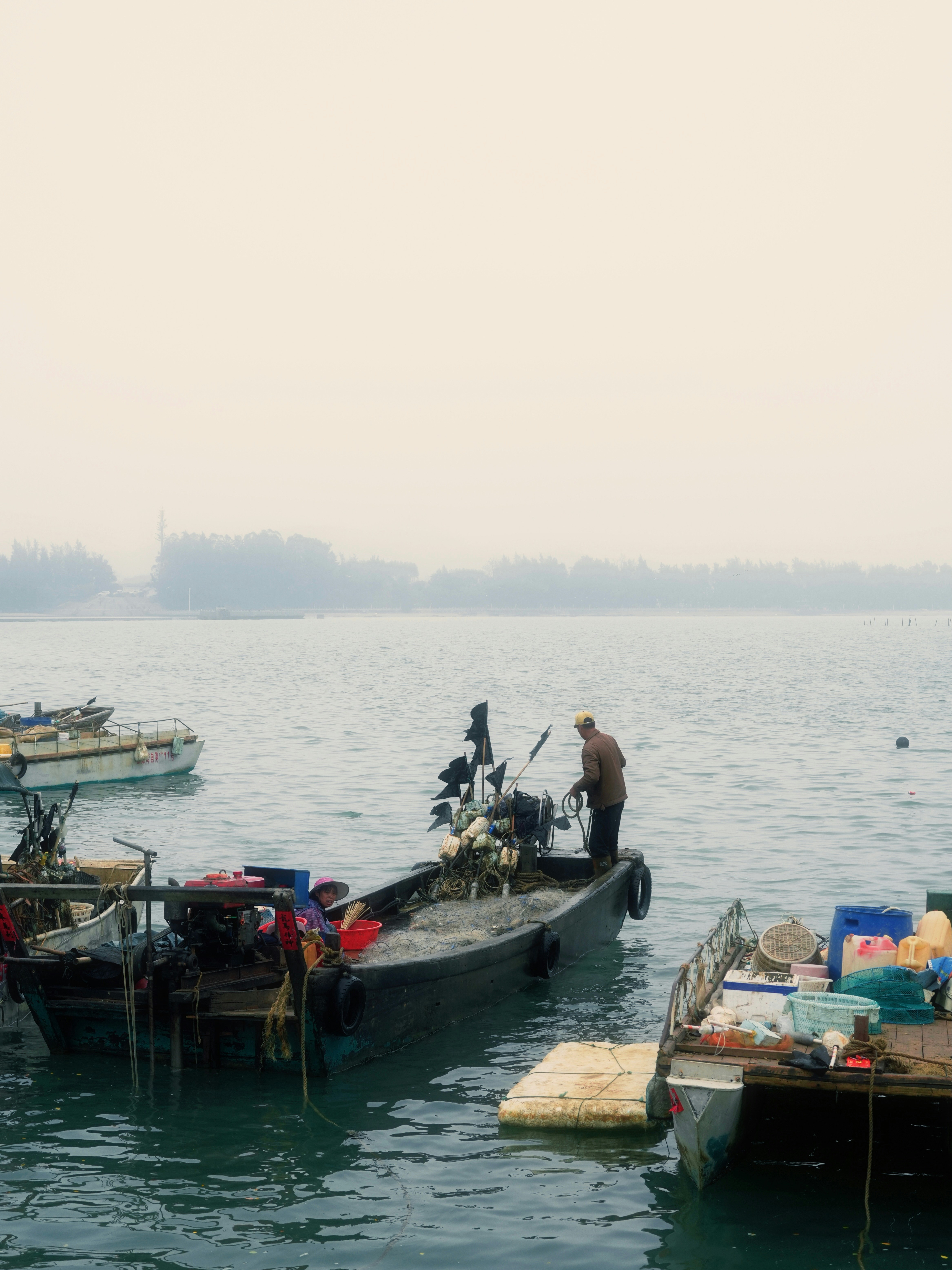 A couple of boats floating on top of a body of water