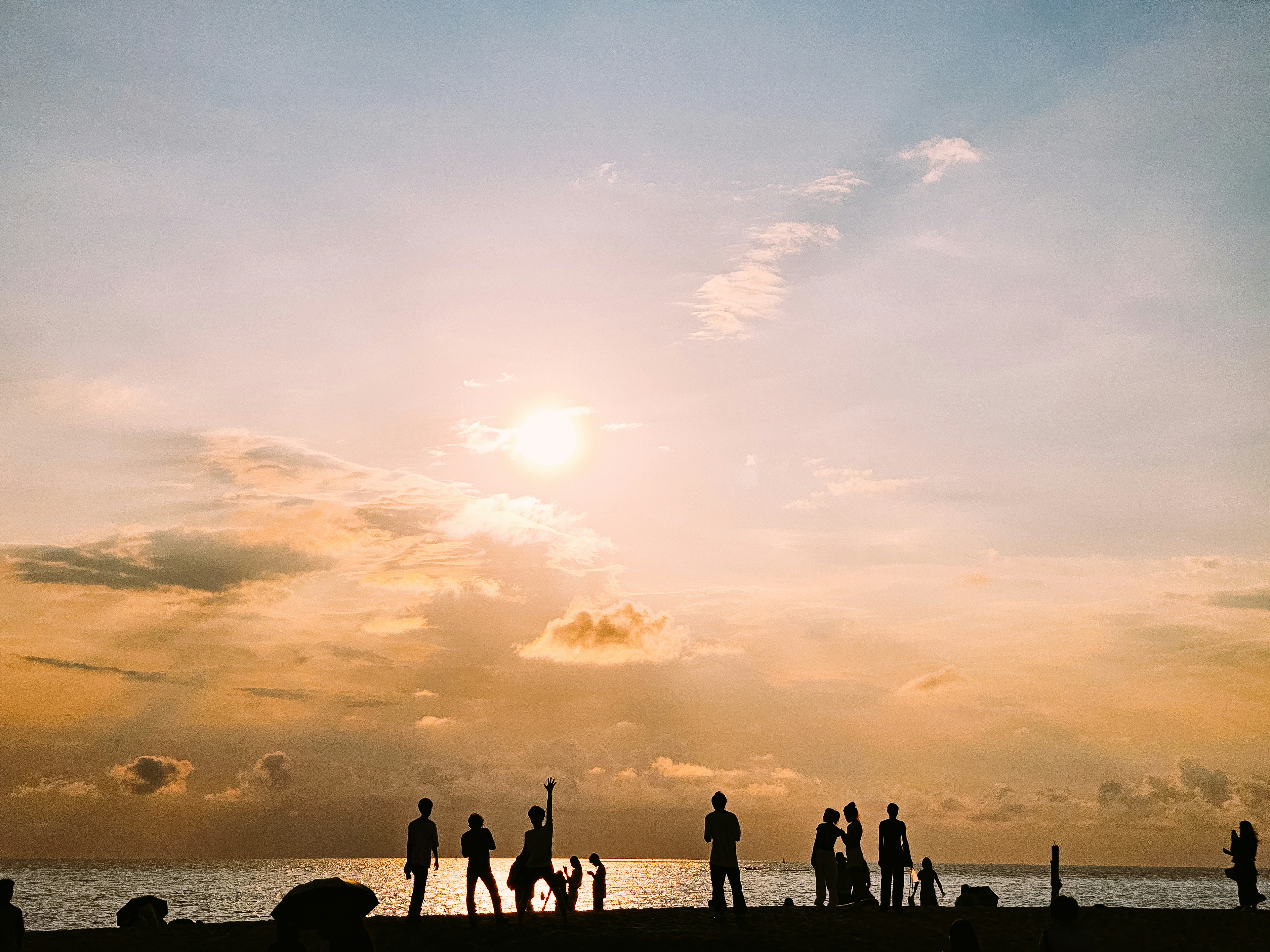 A group of people standing on top of a beach