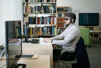 A man sitting at a desk with headphones on