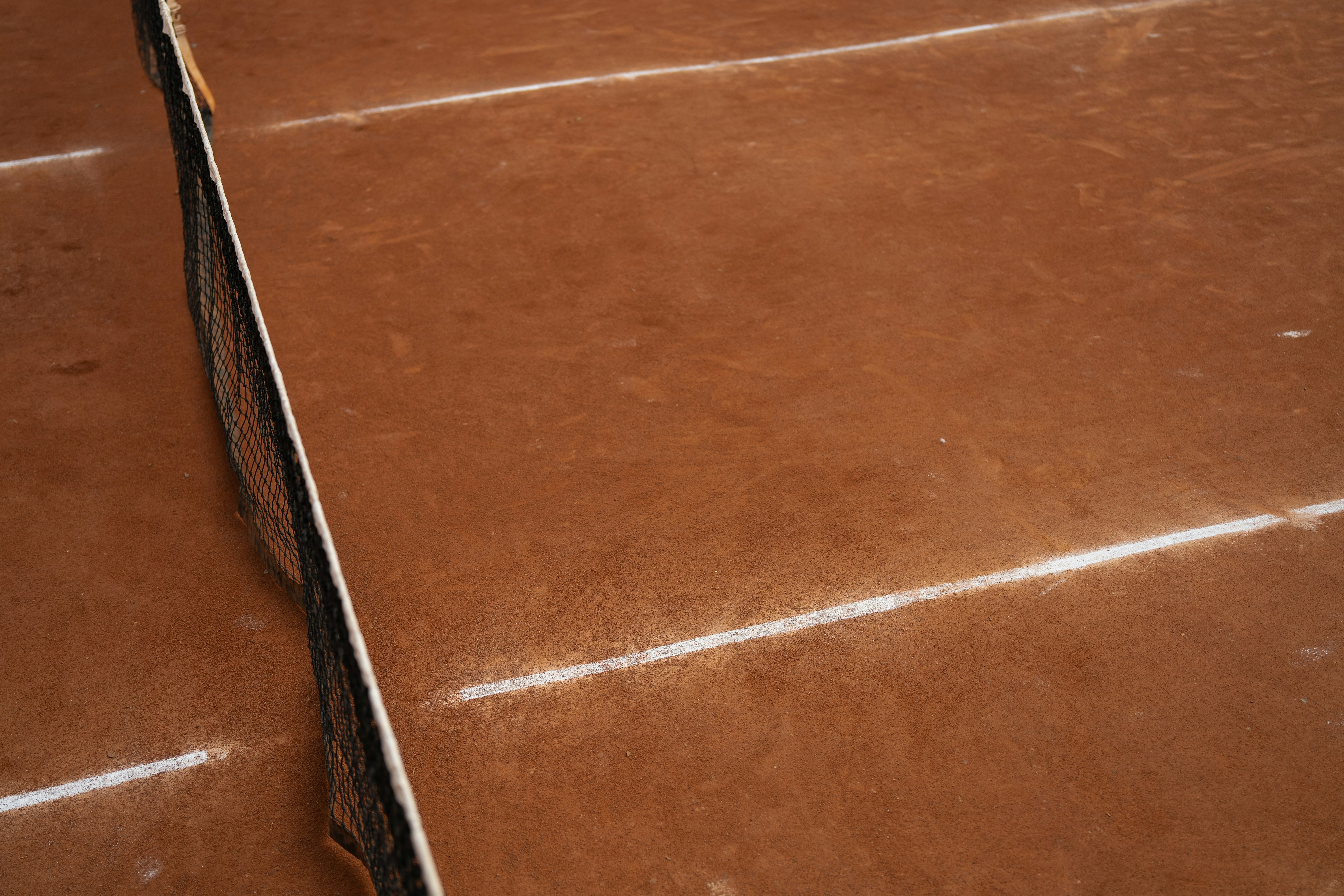 A tennis racket laying on top of a tennis court