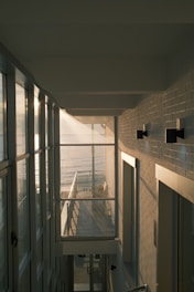 A hallway leading to a balcony overlooking the ocean