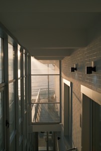 A hallway leading to a balcony overlooking the ocean