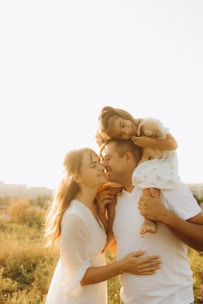 A man holding a little girl in his arms