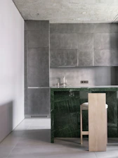 A kitchen with a marble counter top next to a bar