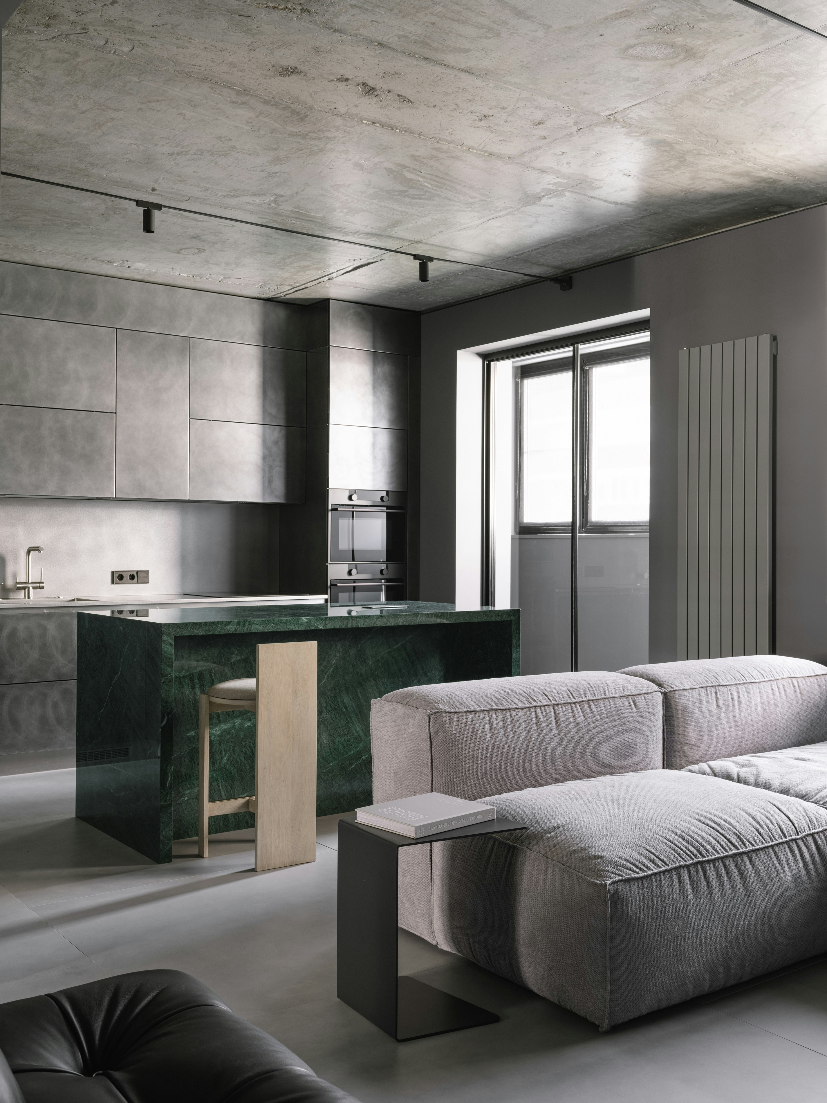 A living room filled with furniture and a kitchen