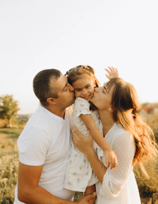 A couple of people that are standing in the grass
