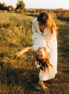 A mother and daughter playing in a field