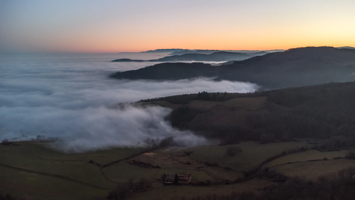 Fog filling the valleys of the Monts du Lyonnais at sunset, near Pollionnay