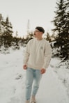A man standing in the snow with trees in the background