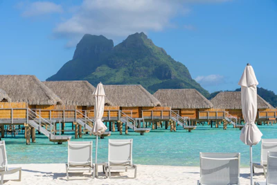 Overwater bungalows in the Bora Bora lagoon below Mount Otemanu