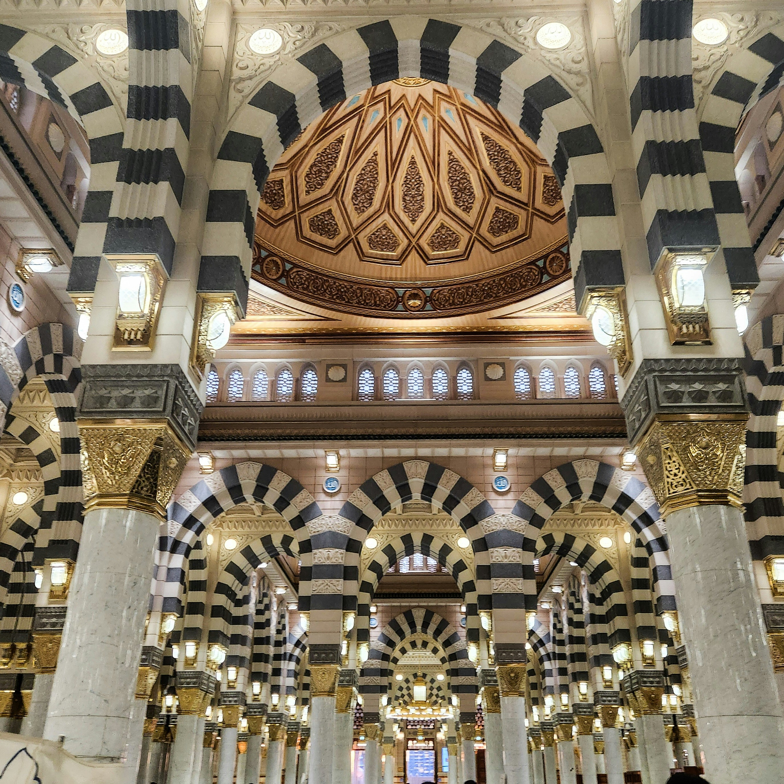 The inside of a large building with columns and arches