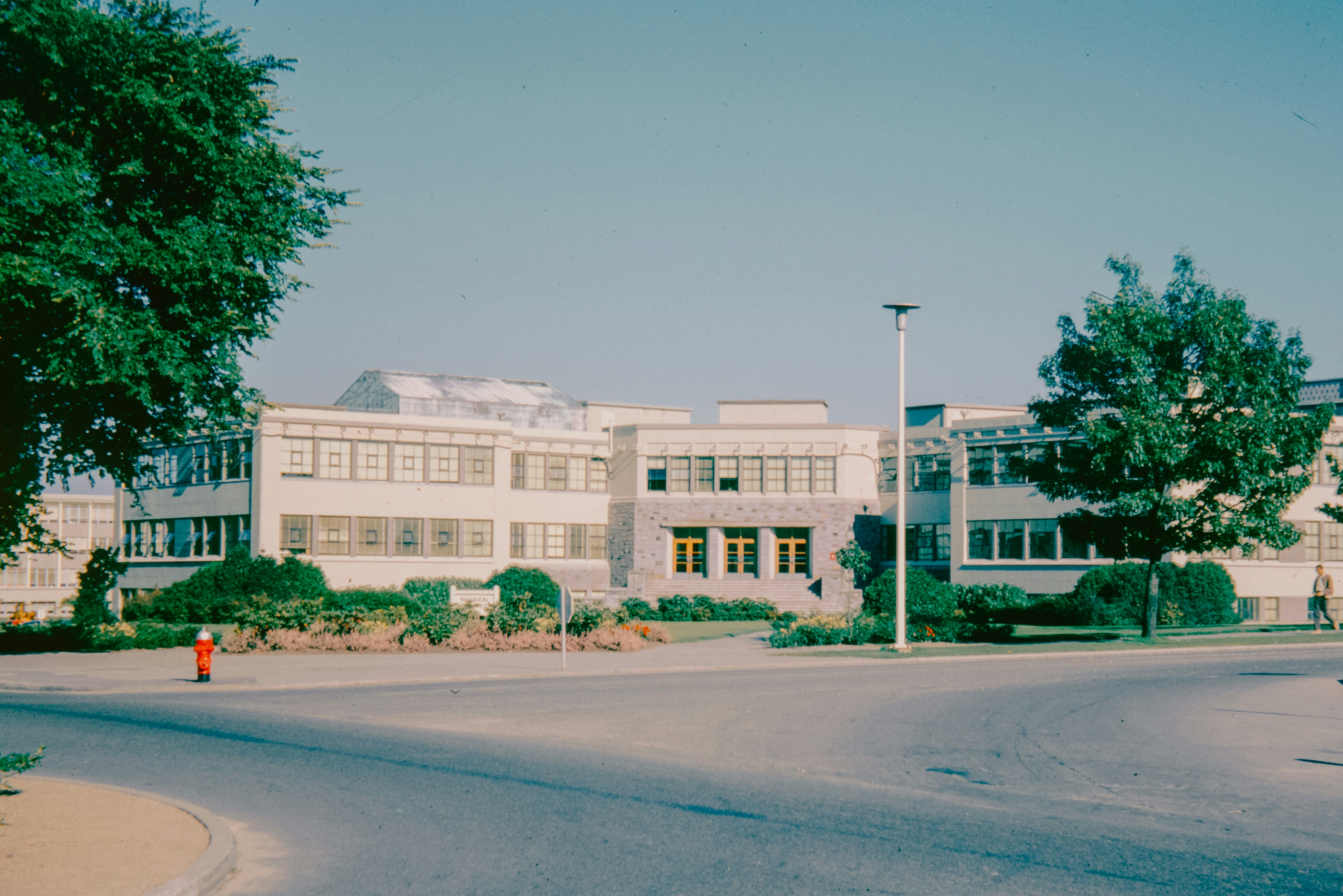 A large white building sitting on the side of a road