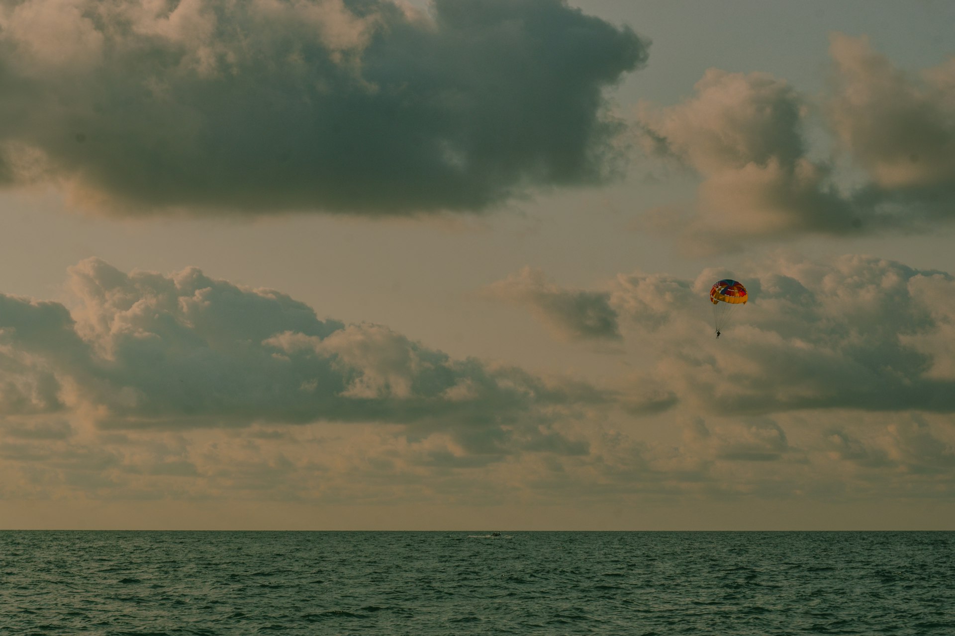 A kite flying in the sky over a body of water