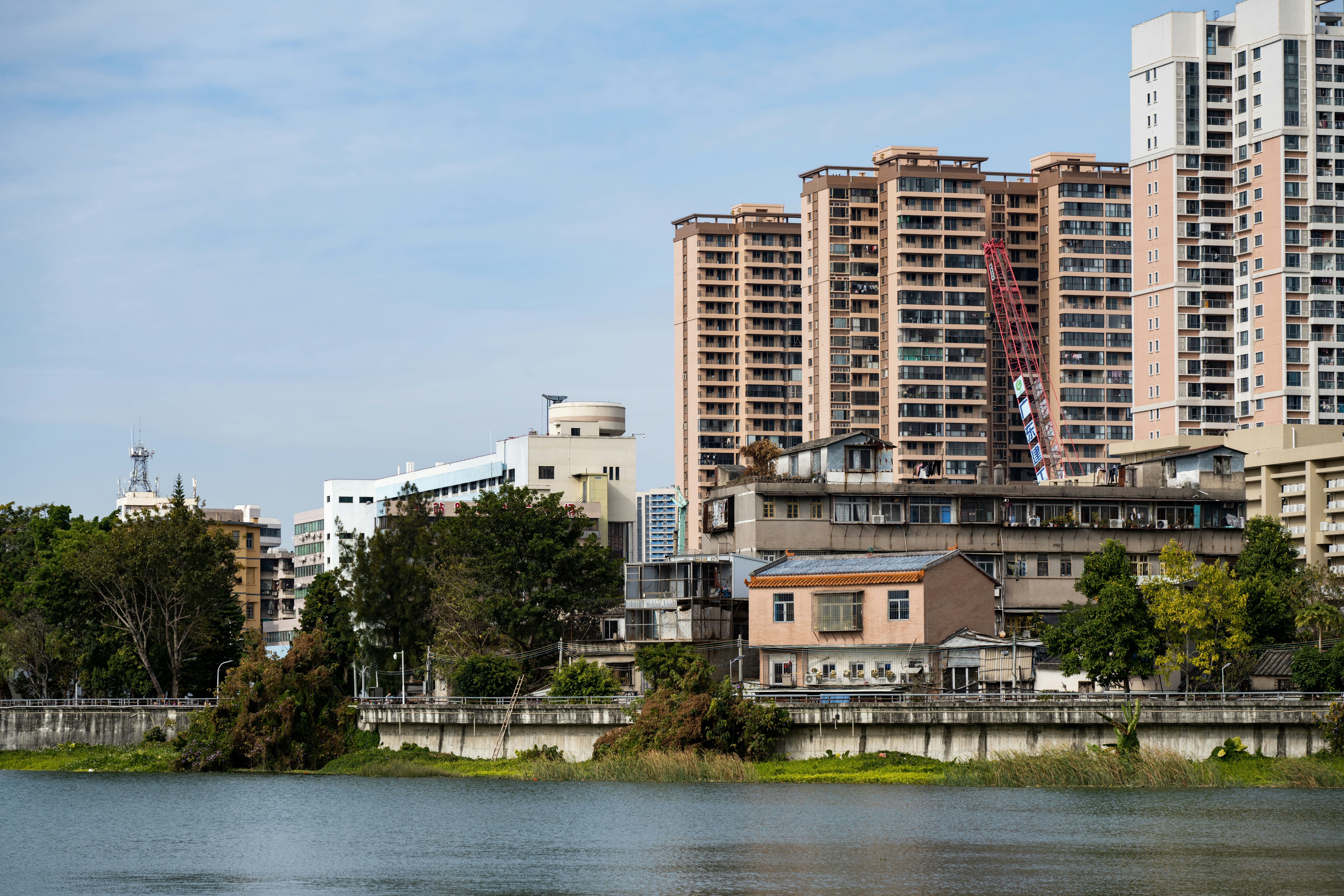 A body of water in front of tall buildings