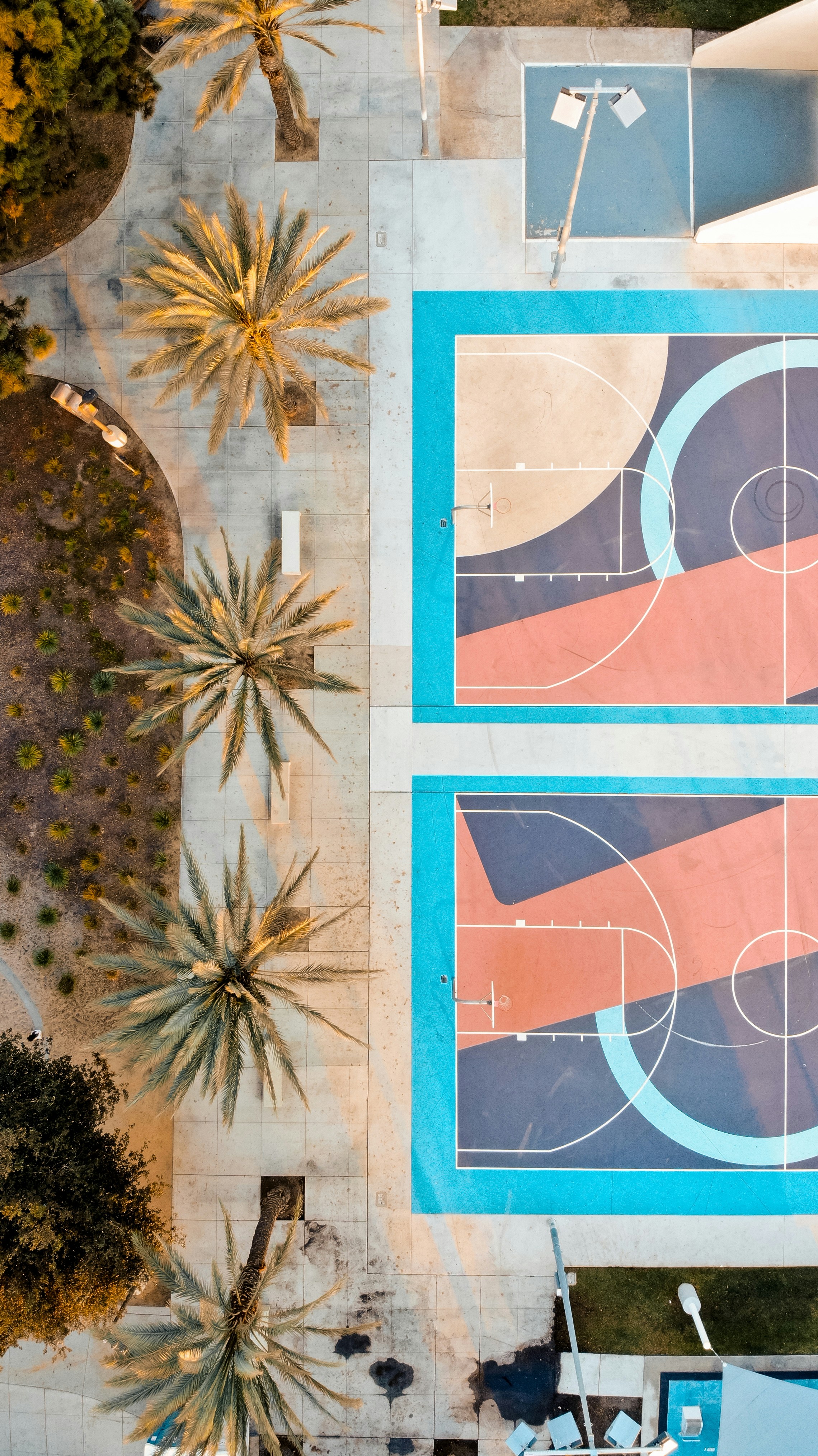 An aerial view of a basketball court with palm trees