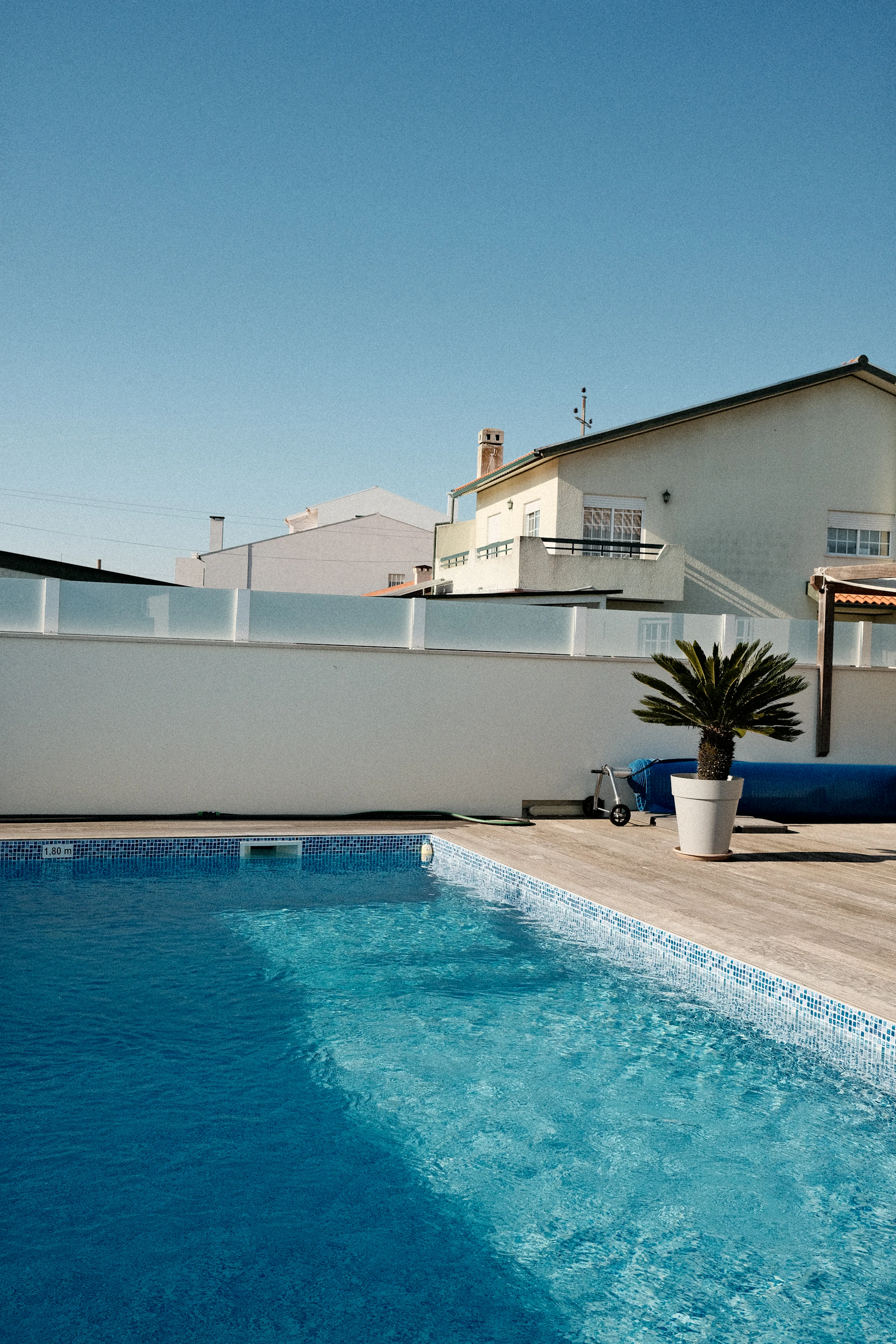A swimming pool with a lounge chair next to it