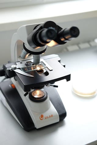 A microscope sitting on top of a white table