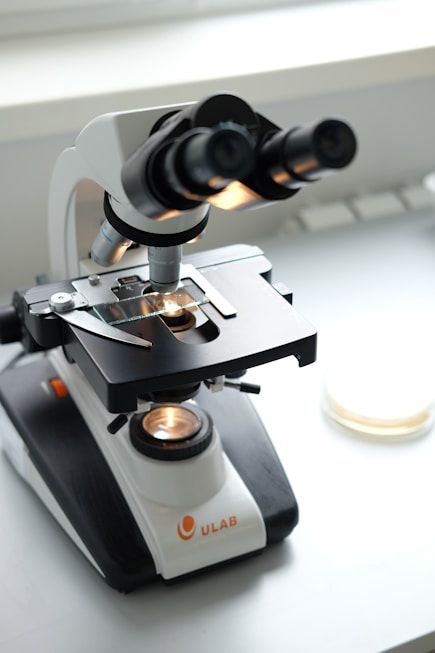 A microscope sitting on top of a white table