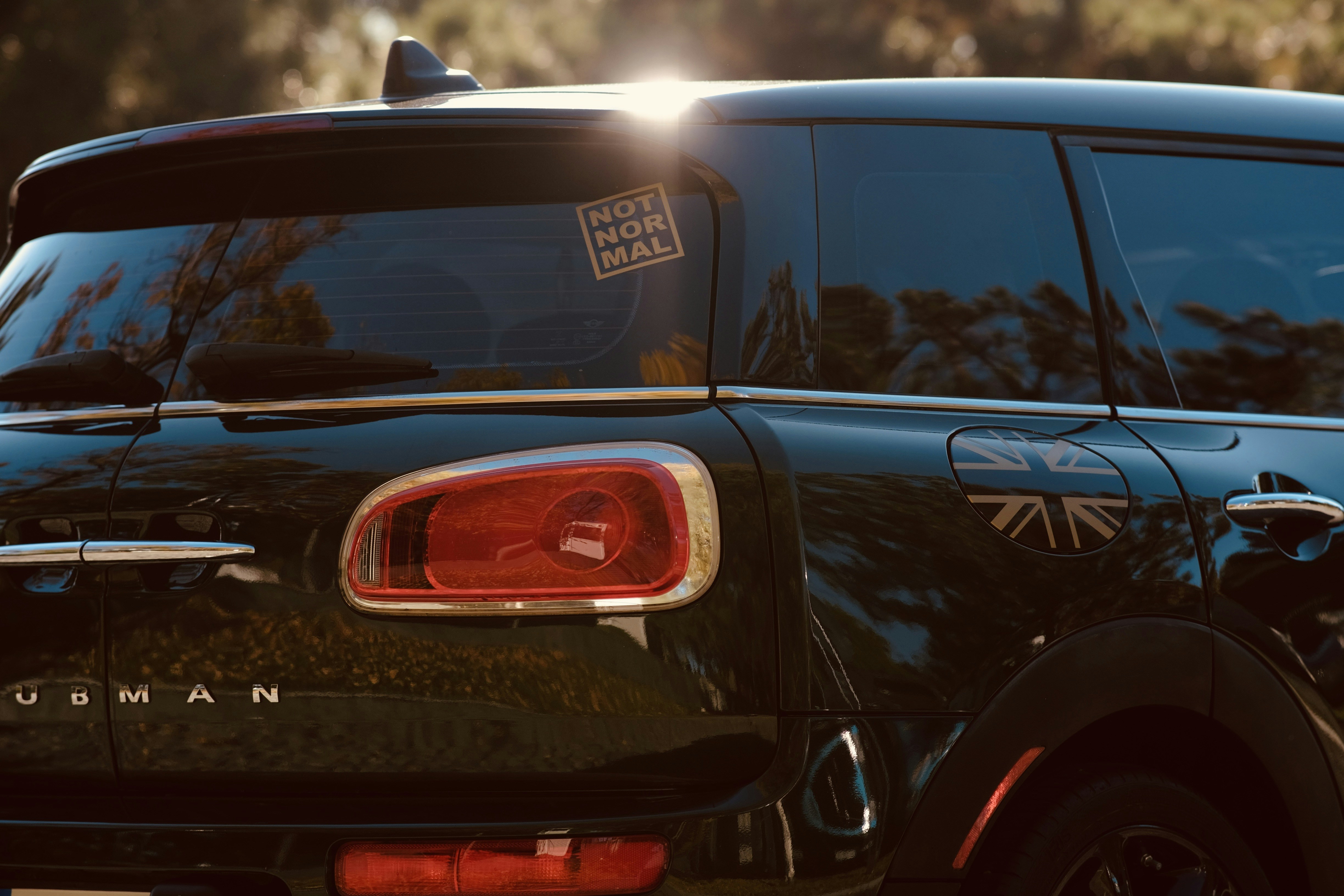 A black minivan parked in a parking lot