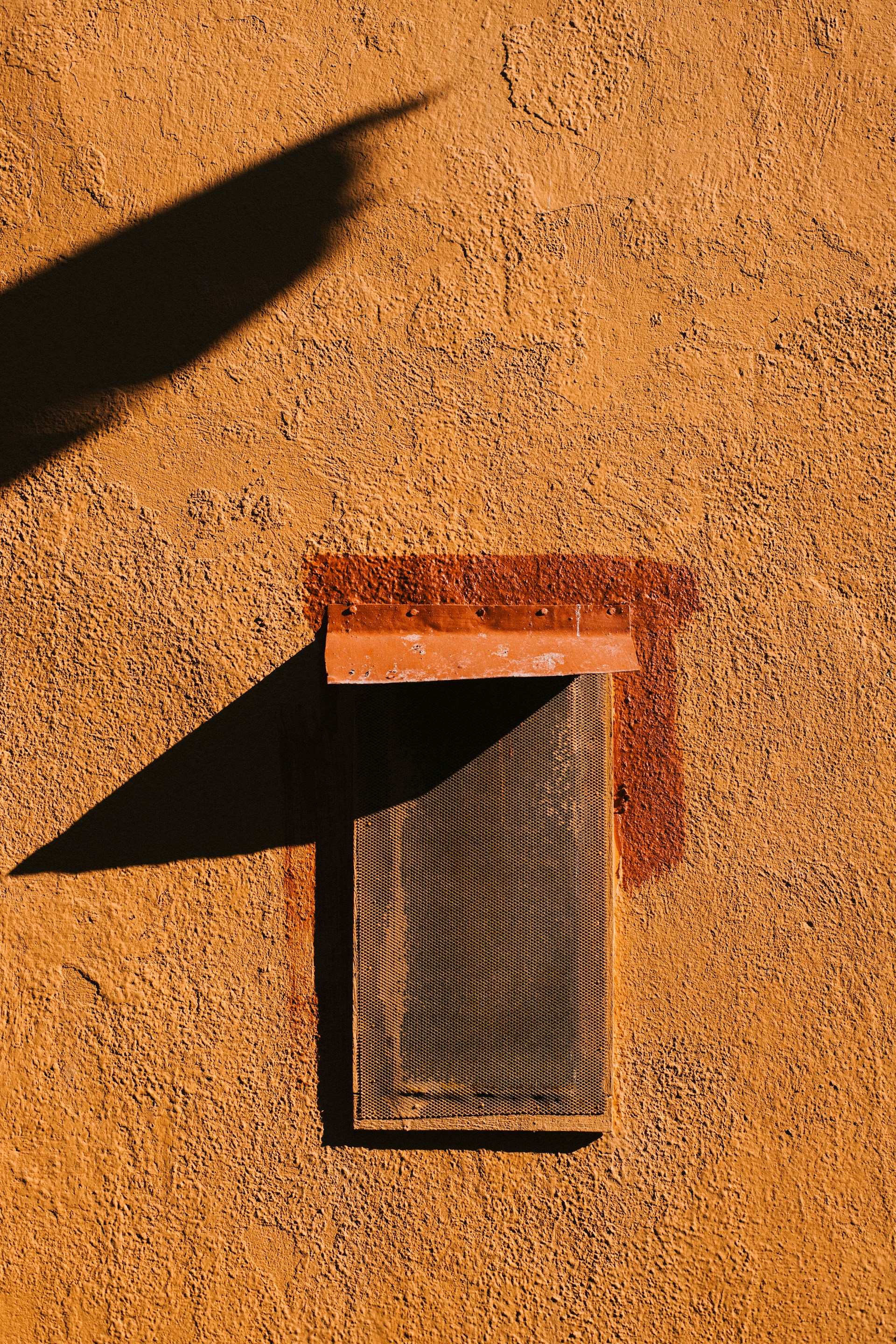 A shadow of a person casting a shadow on a wall