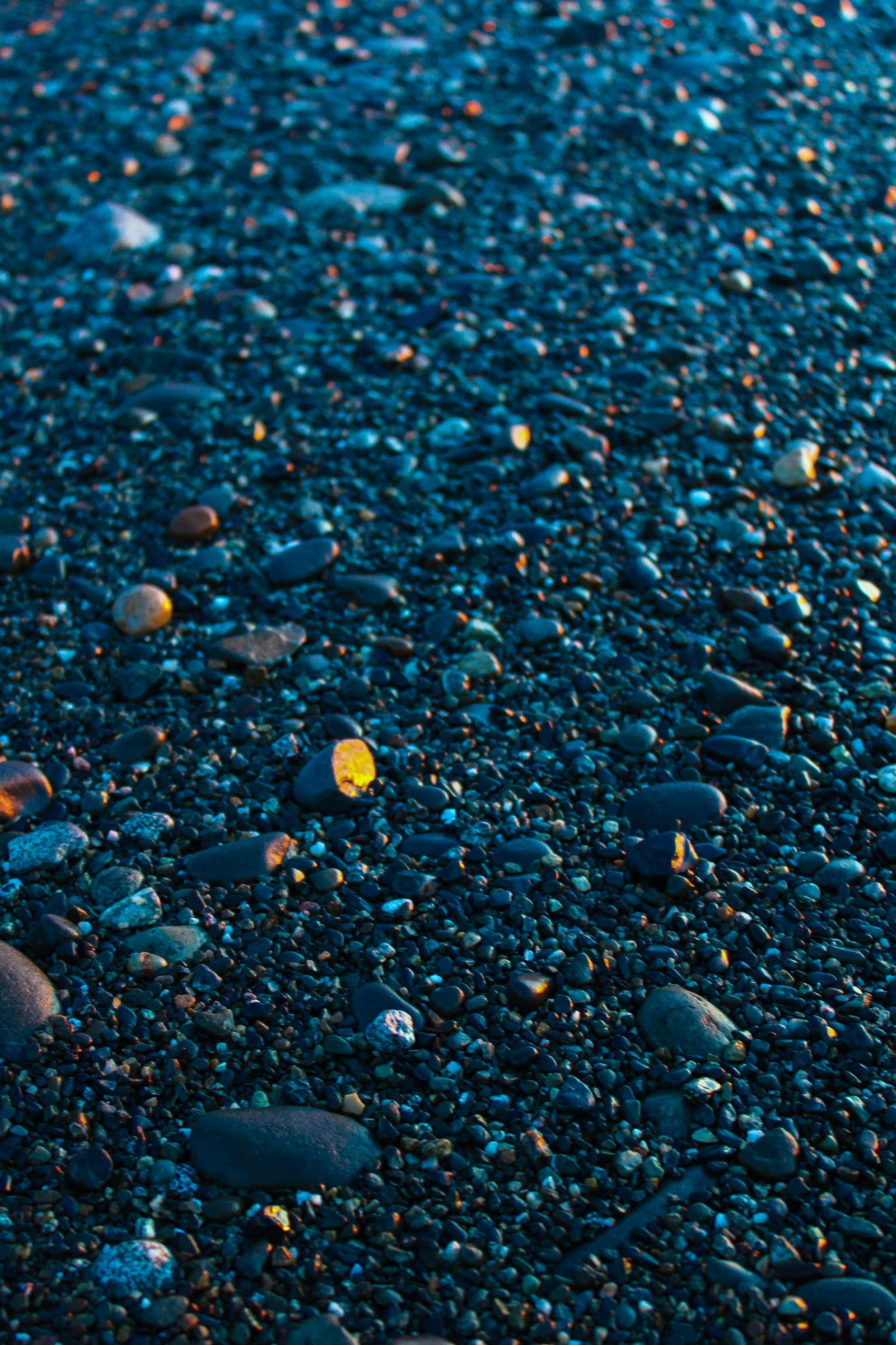 A close up of rocks and gravel on a beach