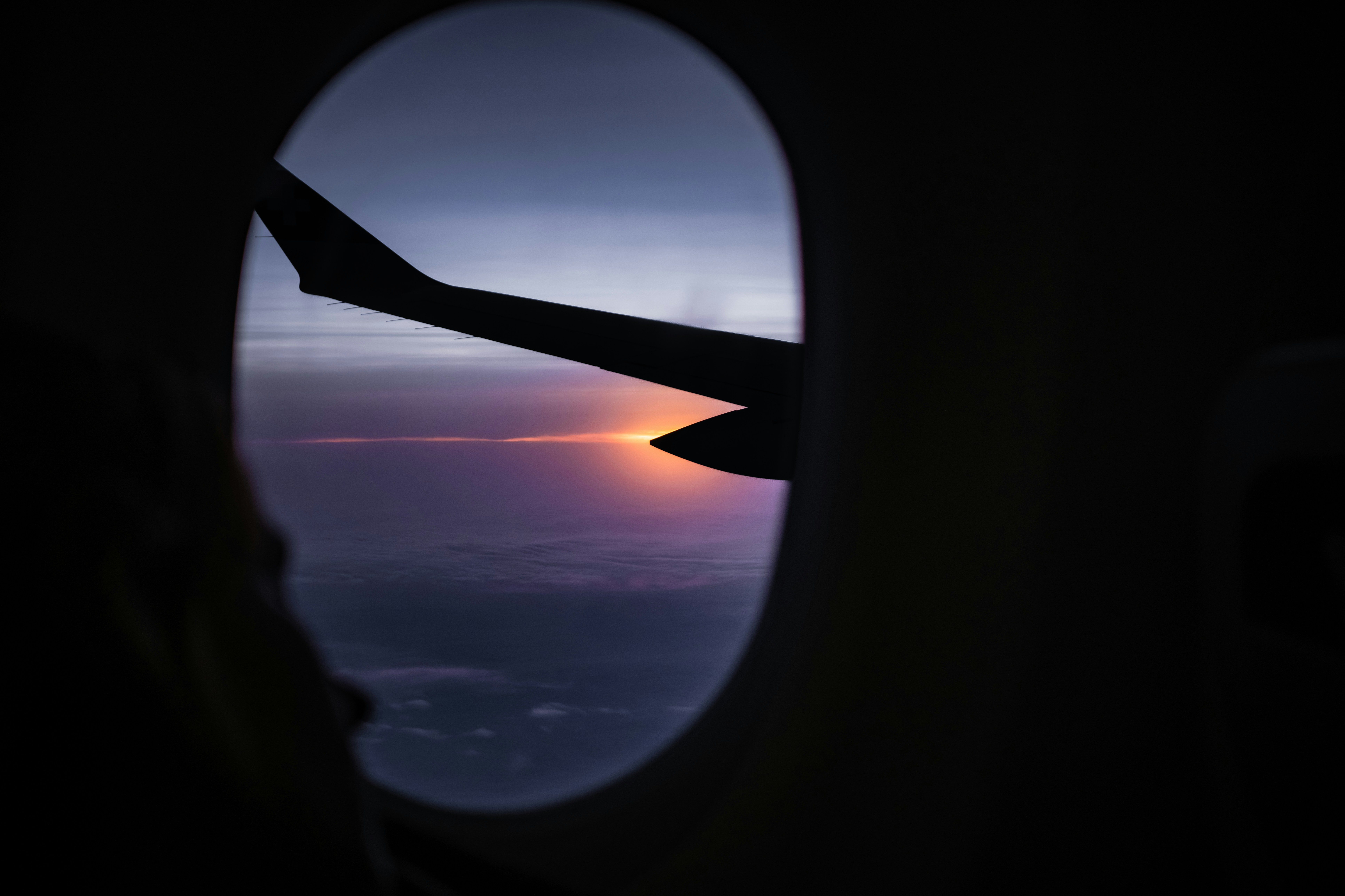 A view of a sunset through an airplane window, 