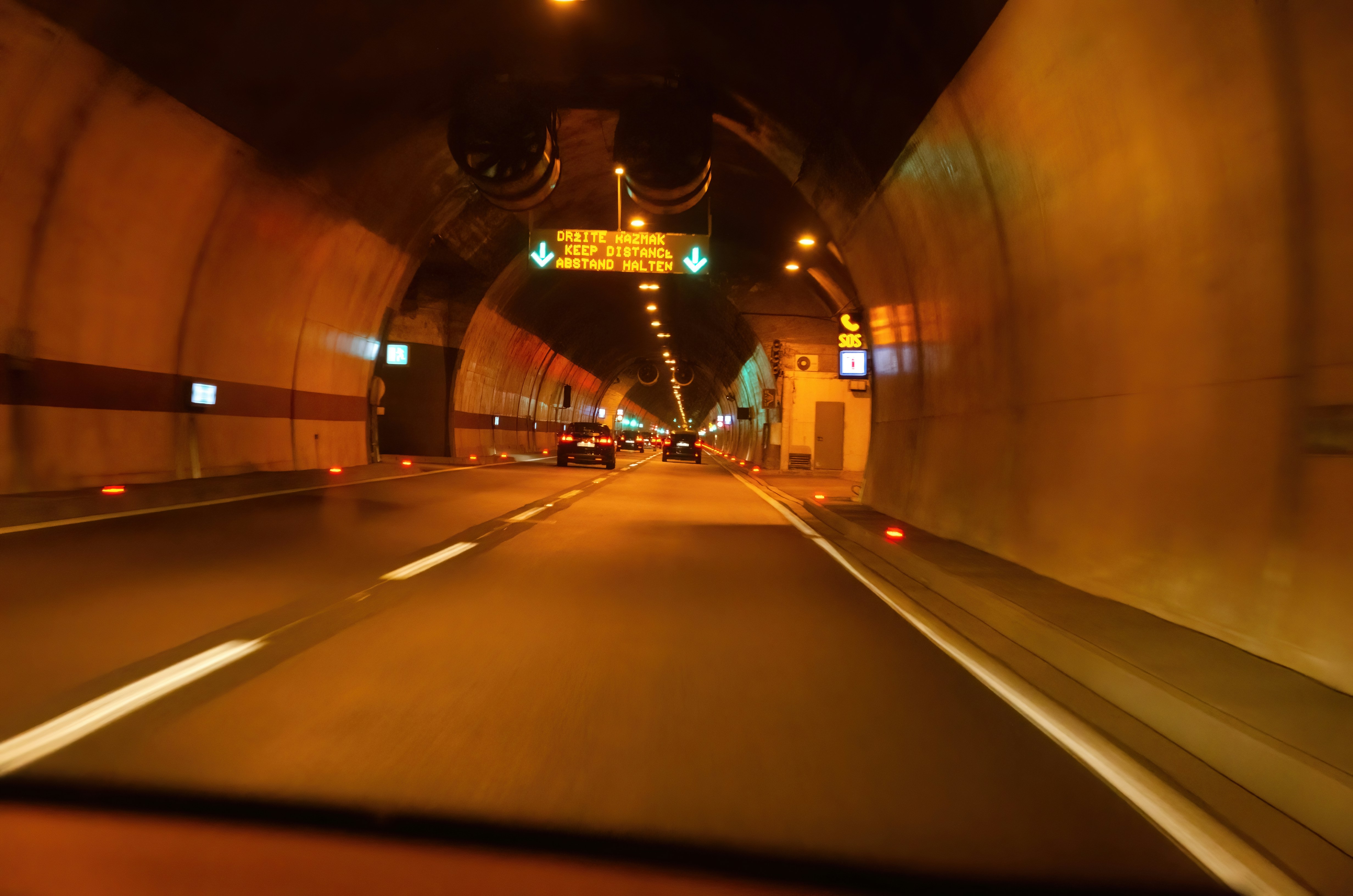 A car driving through a tunnel at night