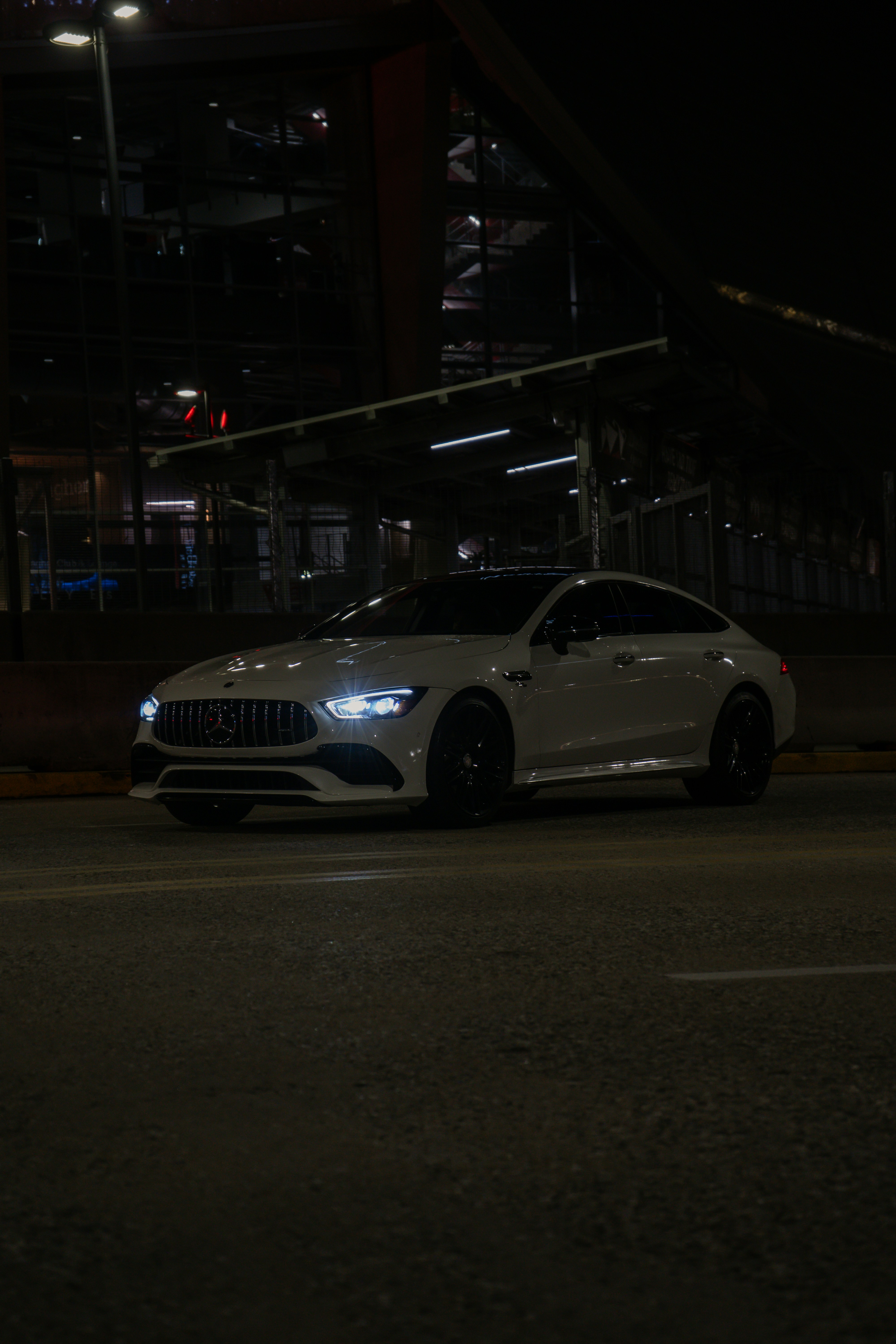 A sleek vehicle under a spotlight.