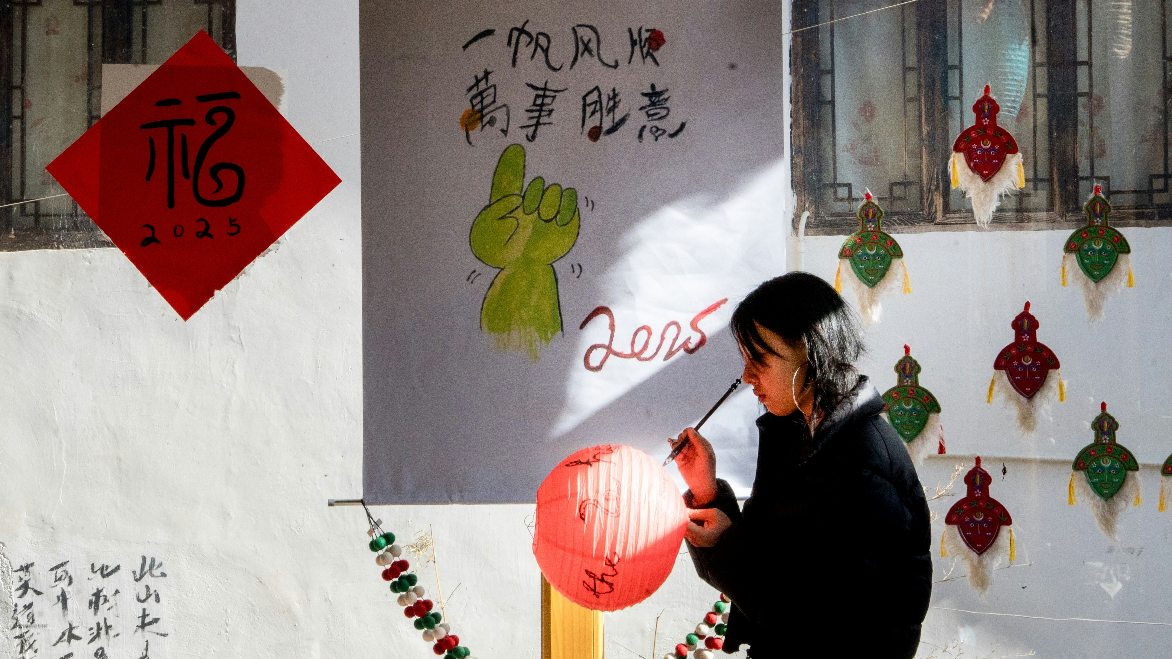 A man holding a red frisbee in front of a building