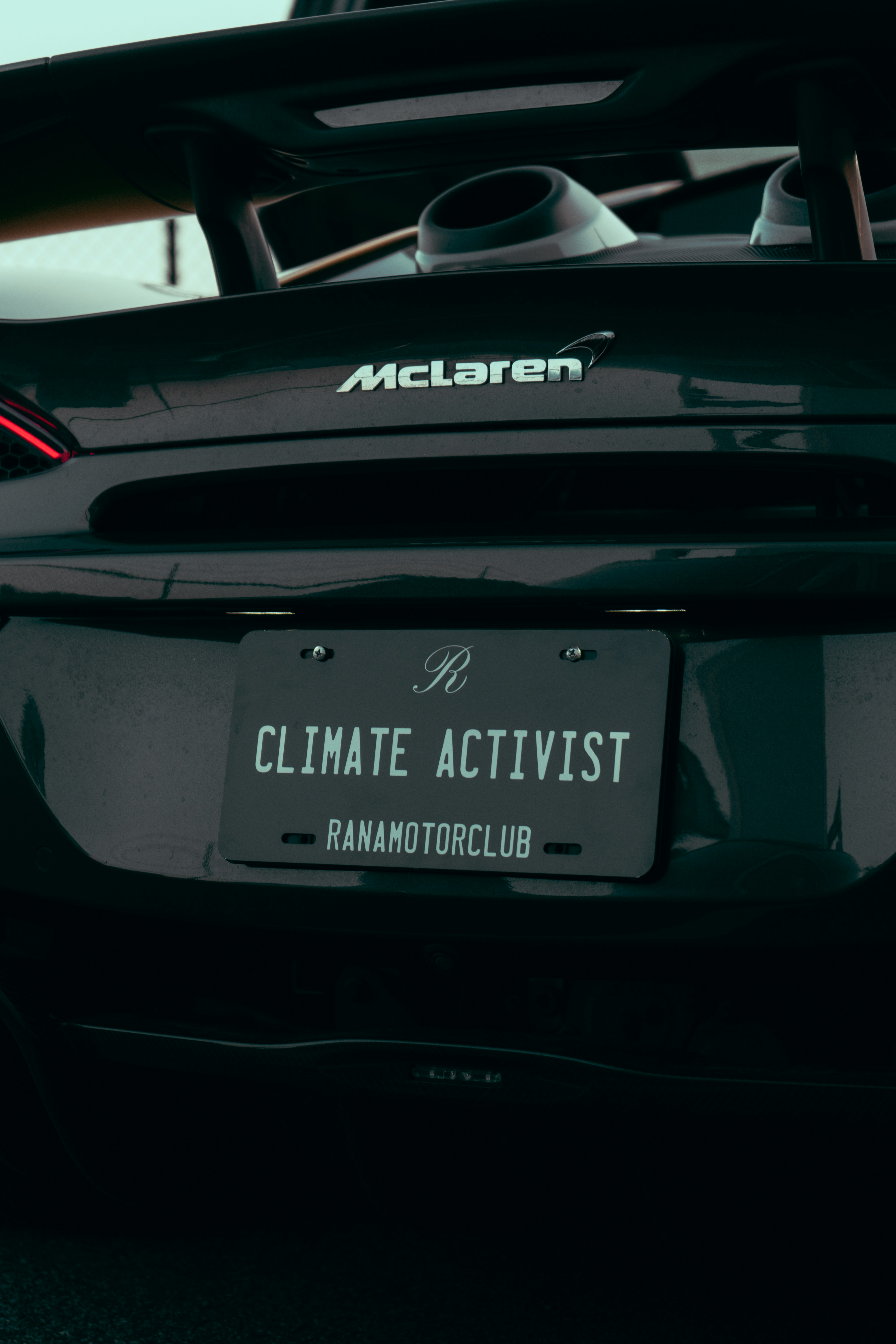 A black sports car parked in a parking lot