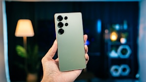 A person holding a cell phone in their hand