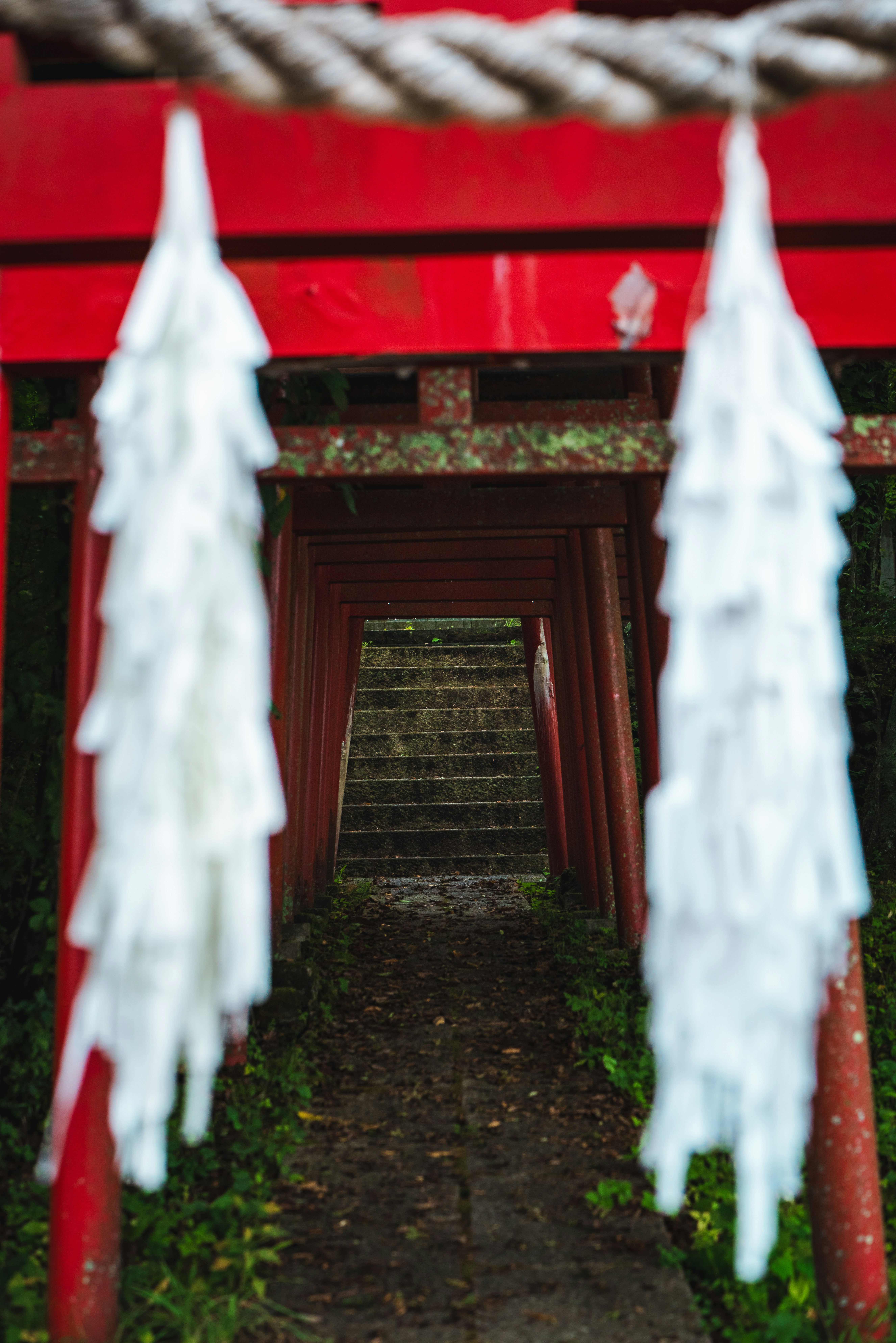 A red gate with white decorations hanging from it