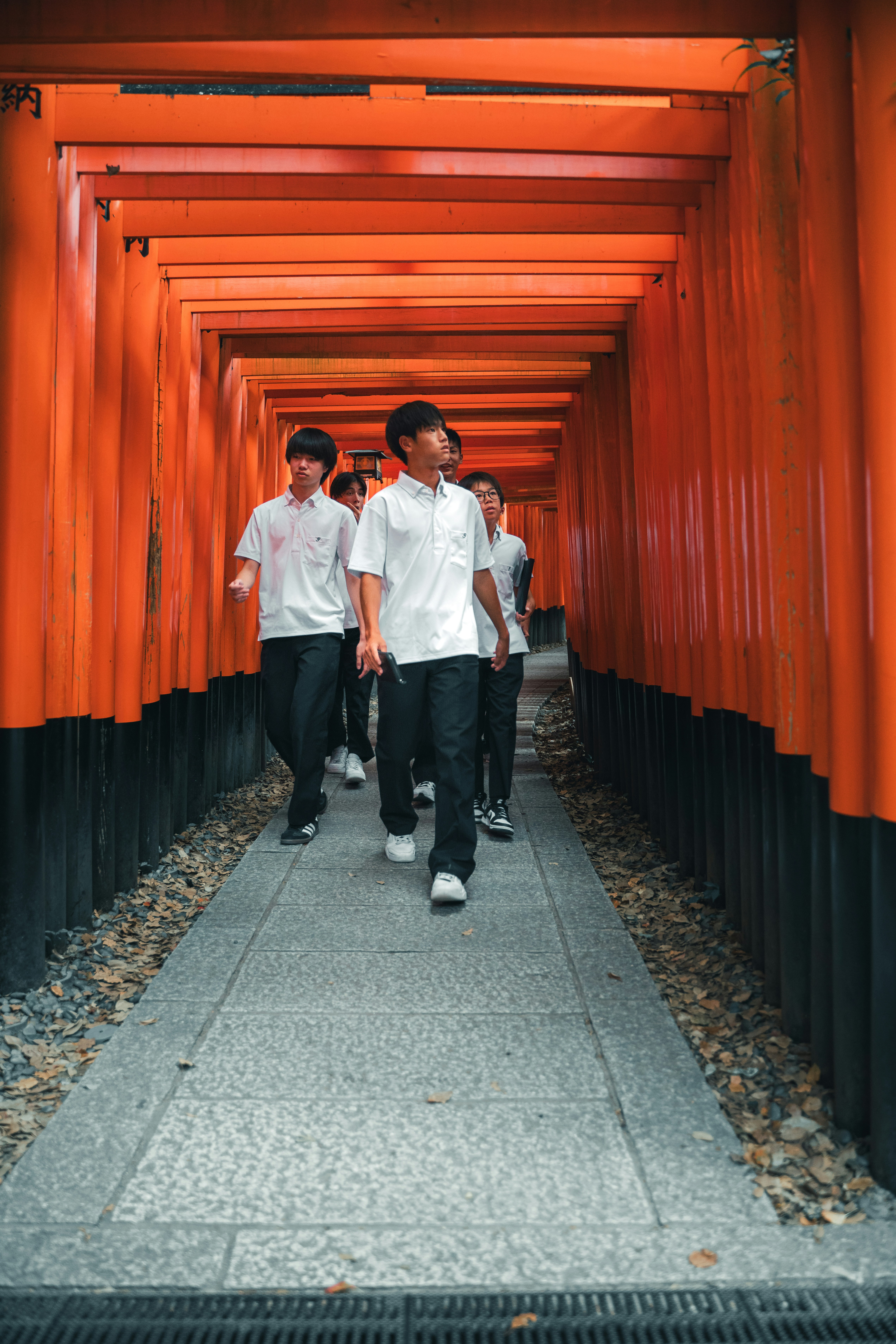 A group of men walking down a long walkway