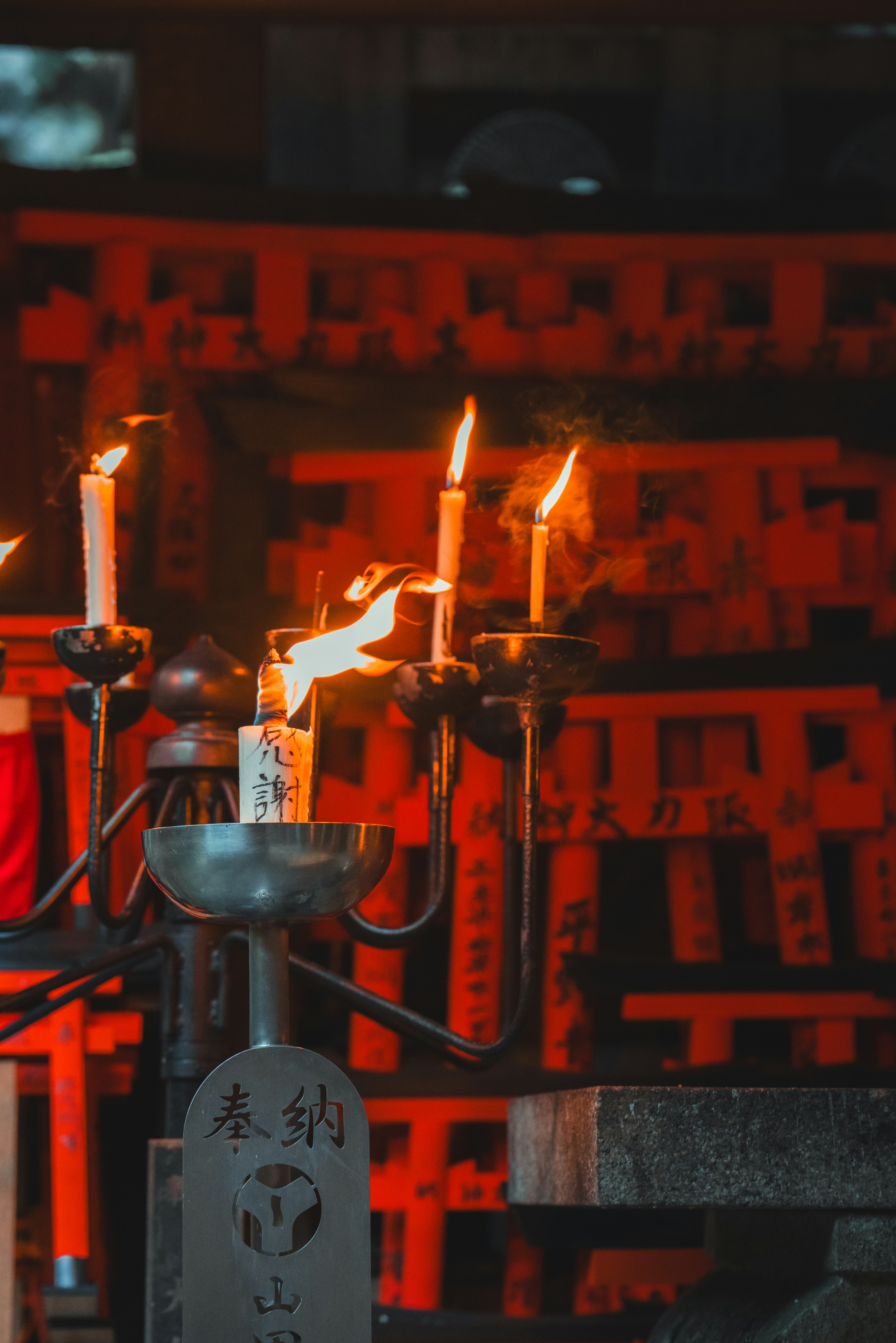 A group of lit candles sitting on top of a table