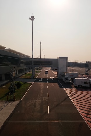 An airport runway with cars parked on the side of it
