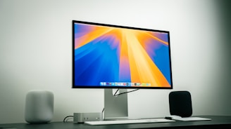 A computer monitor sitting on top of a desk
