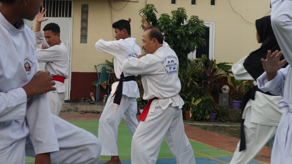 A group of karate students practicing outside